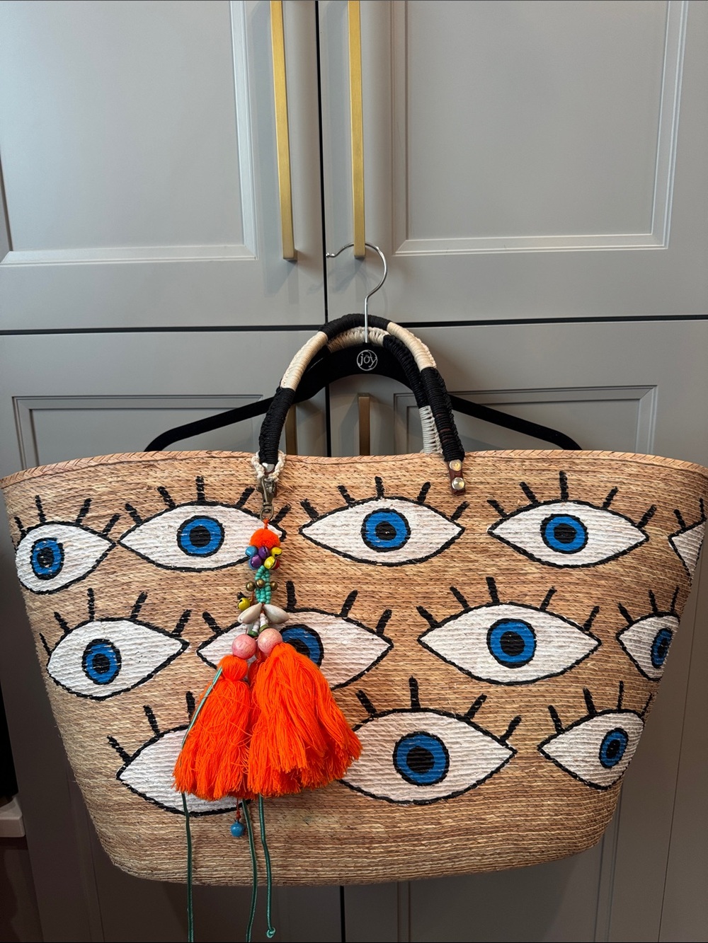 Woven Eye-Print Straw Tote with Blue Eyes and Orange Tassel
